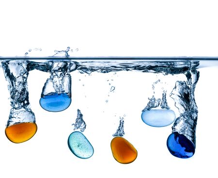 Abstract, minimalistic splash of water on a white background from falling pearlsの写真素材