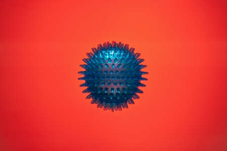 Model of coronavirus bacteria, pandemic on a red background in blood. Copy space.の写真素材