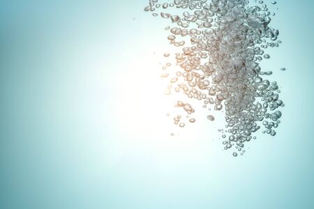 Clean water with air bubbles. Sun rays pierce water. Copy space.の写真素材