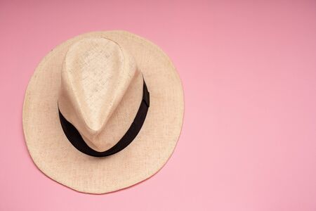 Straw hat on a pink background. Conceptual photo. Close-up. Copy space.の写真素材