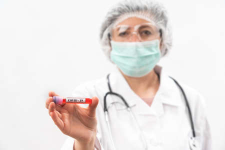 Medic nurse on a white background, shows compares, test tube with virus bacteria.の写真素材