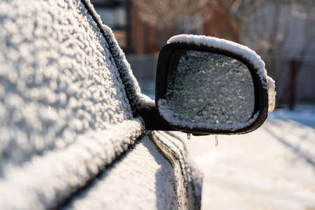 Car covered with ice and icicles after freezing rain. Ice covered car window close up. Bad winter weather, ice stormWinter frosty scenes. High quality photoの写真素材