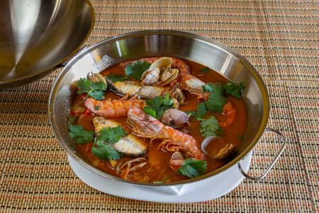 Traditional portuguese seafood dish cataplana. The main ingredients are sea shellfish, shrimp and...