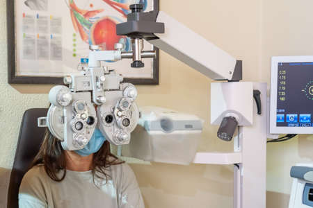 Young woman at the ophthalmologists appointment. Eyesight check. Close-up. High quality photo