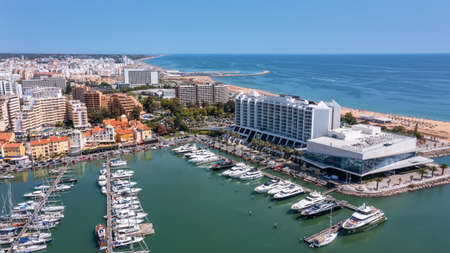 A view from the sky of the tourist Portuguese town of Vilamoura, with Yachts and sailboats moored in the port on the dock. High quality photoの写真素材