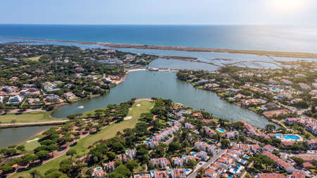 Aerial overview of luxury villas located around Quinta do Lago, Algarve, Portugal, Europe. Drone shot in the green zone. High quality photoの写真素材