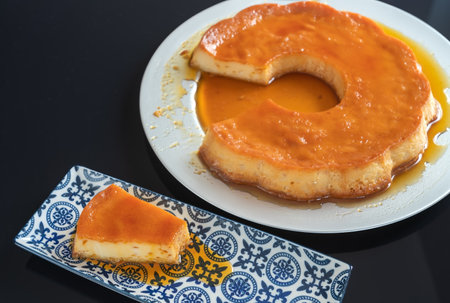 Pudding, delicious Brazilian condensed milk dessert, cut into pieces, on a plate. High quality photo