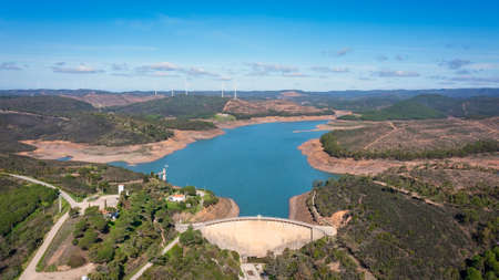 Aerial. Photo from sky, dams filled with water Odiaxere. Bravura Portimao. in the background, a park of wind generators for clean ecological electricity. High quality photoの写真素材