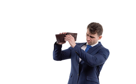 Handsome man in a suit turns over an empty wallet. Financial crisis and bankruptcy concept. Iwhite...