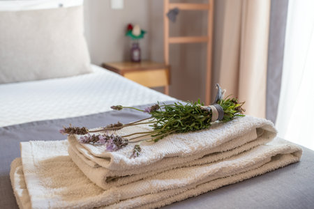 Close-up of a towel on the bed with lavender flowers for decoration and aromatherapy.の写真素材