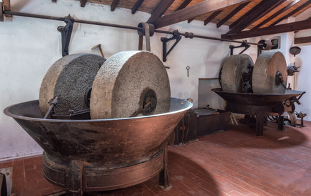 Olive oil press is installed in premises of the ancient equipment for production of olive oil, stone mill and mechanical press, olive oil mill.の写真素材