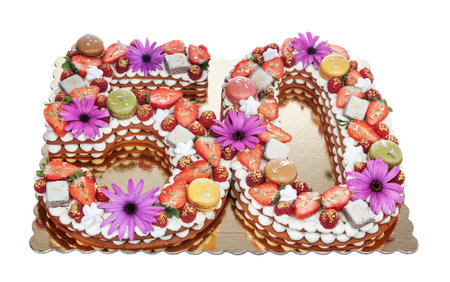 Anniversary cake in the shape of the number 50 years with puff pastry with marshmallows, strawberries and flowers.の写真素材