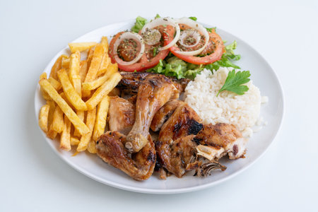 Grilled chicken rice fries salad, roasted chicken pieces with jasmine rice, golden fries and fresh...