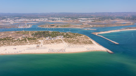 Aerial view of serene beach with golden sand and turquoise water, showcasing natural beauty and tranquility in coastal environment. Tavira Portugal Algarveの写真素材