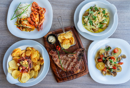 Delicious assortment of gourmet dishes featuring grilled shrimp, steak, pasta, and crispy chips...