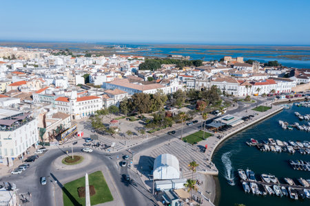 Visitors walk around Faros Old Town near the Ria Formosa dock, enjoying the sunny weather and the...