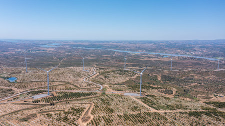 Wind green energy. Wind energy generators stand tall in a vast landscape, showcasing ecological...