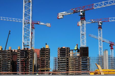 construction site of a modern high-rise residential complex with high tower cranes