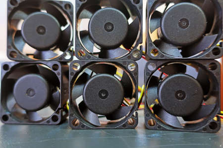 six black small cooling fans stacked on top of each otherの写真素材