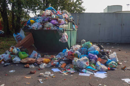 03 October 2020 Russia, St. Petersburg, an overflowing trash can with rubbish lying aroundの写真素材