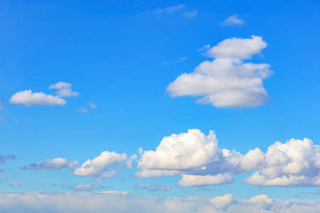 Background image: blue skies with white clouds floating in height