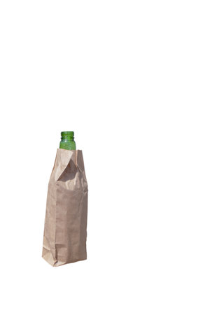green bottle in paper bag isolated on white background with place for textの写真素材
