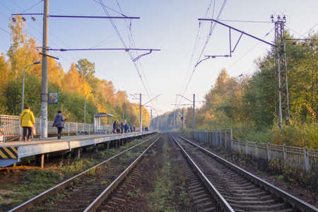 October 2, 2021, Russia, Leningrad region, People walking on a railway platform in the autumn morningのeditorial素材