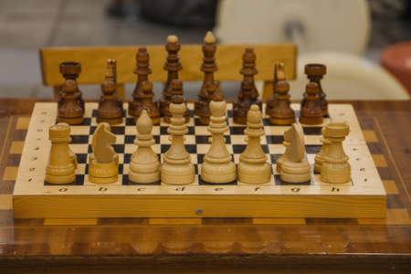 White and black chess pieces placed on the board before the start of the game