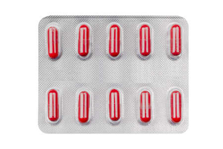 blister pack with medicine in red capsules isolated on white background
