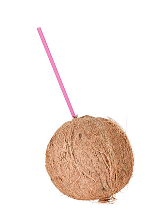 round fresh coconut with pink drinking straw isolated on white backgroundの写真素材