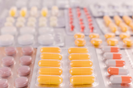 Blister packs with colorful tablets and pills, pharmaceutical industry.
