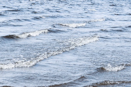 Background image: Waves on the sea, restless water surface, waves running ashoreの写真素材