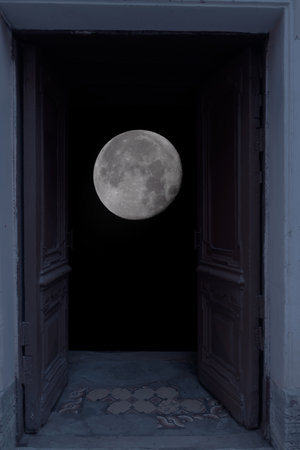 view of the full moon through the open double doors in the entranceの写真素材