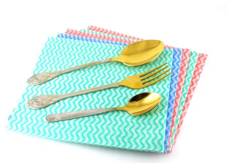Old fork and spoons on the color napkins