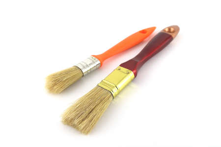 Paint brush with brown and orange handles on white