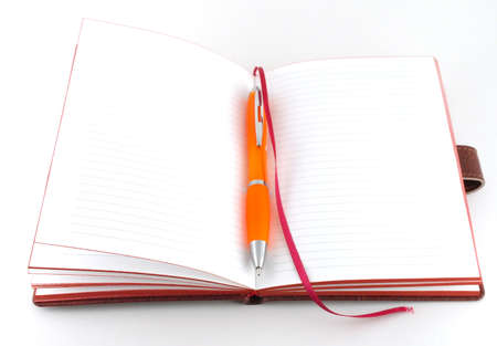 Notebook and orange pen