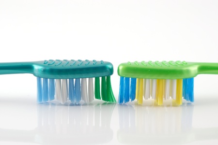 Two tooth-brushes over white