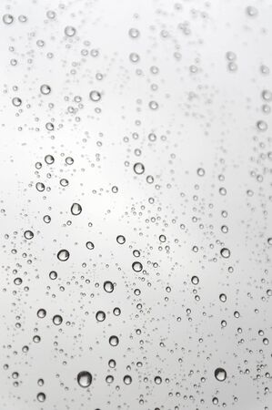 Drops of rain on the inclined window (glass). Shallow DOF.の写真素材