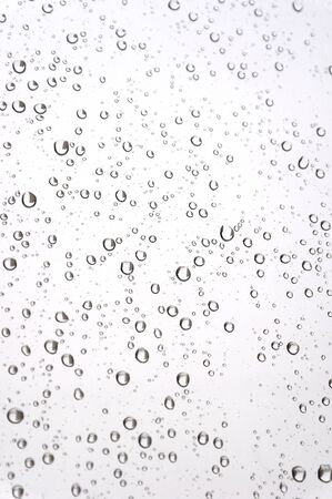 Drops of rain on the inclined window (glass). Shallow DOF.の写真素材