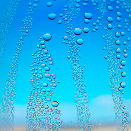 Abstract background. Drops of water on the crooked glass, shallow dofの写真素材