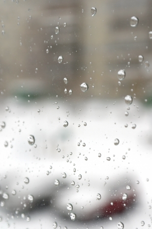 On a winter raining day. Drops of water on the window. Shallow DOFの写真素材
