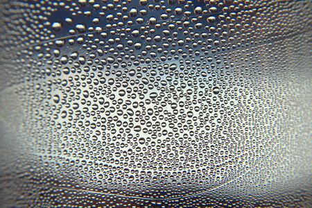 Drops of water on the crooked glass の写真素材