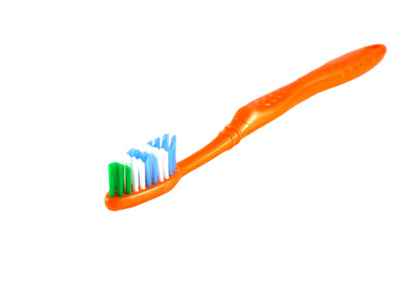 Orange toothbrush over white