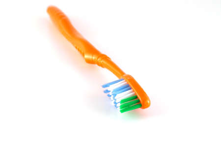 Orange toothbrush over neutralの写真素材