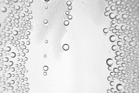 Drops of water on the crooked glassの写真素材