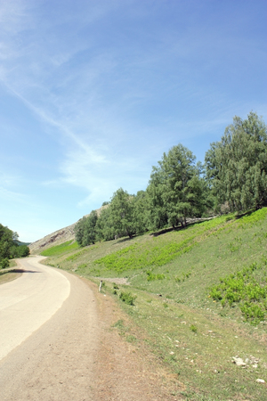 Summer lanscape with highway and trees on the mountainの写真素材