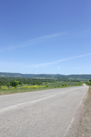 Beautiful summer landscape with road to mountainsの写真素材
