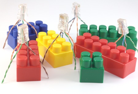 Color components of child's meccano and abstract workers over white