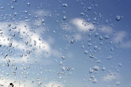 Abstract background, water drops on a window glass, rainy dayの写真素材