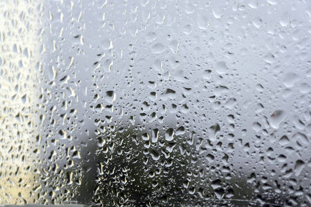 On a summer raining day. Drops of water on the window. Shallow DOF